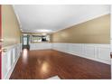 Spacious living room boasts beautiful hardwood floors, elegant wall trim, and ample natural light at 125 Greyson Cir, Goose Creek, SC 29445