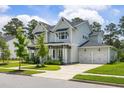 Stunning two-story home with attached two-car garage, well-maintained landscaping, and inviting curb appeal at 125 Integrity Ln, Charleston, SC 29492