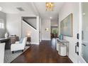Elegant foyer with hardwood floors, stylish console table and bench seating, leading to staircase and living spaces at 125 Integrity Ln, Charleston, SC 29492
