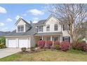 Charming home showcasing mature landscaping, a spacious front yard, and a welcoming front porch at 1458 Clarendon Way, Mount Pleasant, SC 29466