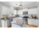 Bright kitchen featuring white cabinets, stainless steel appliances, granite counters, and a center island at 1458 Clarendon Way, Mount Pleasant, SC 29466