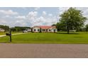 Charming single-story home with a red roof and an expansive green lawn at 160 Syrr Run Rd, Saint George, SC 29477