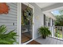 Up close, exterior view of front door with a wreath and home number above the covered porch at 1604 Macoma Dr, Mount Pleasant, SC 29466