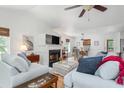 Bright living room featuring a fireplace, hardwood floors, large couches, and open layout at 1604 Macoma Dr, Mount Pleasant, SC 29466