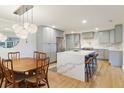 Bright, open kitchen featuring modern cabinets, a large island, stainless steel appliances, and wood flooring at 1673 Mcclain St, Charleston, SC 29407