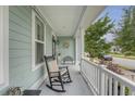 Inviting front porch with rocking chair offering a relaxing outdoor space at 1822 Grovehurst Dr, Charleston, SC 29414