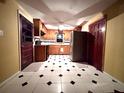 Cozy kitchen with wood cabinets, black and white tiled floors, stainless steel refrigerator, and modern appliances at 1871 Grimball Rd, Charleston, SC 29412