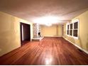 Spacious living room with hardwood floors, a brick fireplace, and abundant natural light at 1871 Grimball Rd, Charleston, SC 29412