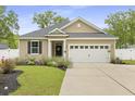 Inviting home exterior with well-manicured lawn, charming curb appeal, and attached garage at 201-B Mcmakin Dr, Summerville, SC 29483