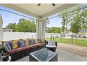 Cozy covered patio featuring comfortable seating, a stylish coffee table, and serene backyard views at 201-B Mcmakin Dr, Summerville, SC 29483