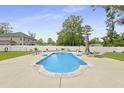 Relaxing backyard with a refreshing pool, lounge chairs, and privacy fence, perfect for summer at 201-B Mcmakin Dr, Summerville, SC 29483
