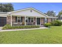 Attractive brick home featuring a covered front porch and well-kept landscaping at 212 Columbia Dr, Ladson, SC 29456