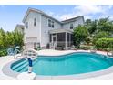 Backyard features an in-ground pool, screened porch, and a fenced yard perfect for entertaining at 216 Foxbank Plantation Blvd, Moncks Corner, SC 29461