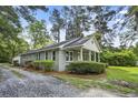 Charming one-story home with a welcoming front porch and well-maintained landscaping at 217 Quaker Rd, Saint George, SC 29477