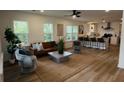 Bright, open-concept living space with barstool seating, modern lighting, and lots of natural light at 217 Quaker Rd, Saint George, SC 29477