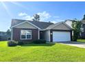 Charming one-story brick home with attached two car garage and well maintained lawn at 286 Westbrooke Rd, Summerville, SC 29486