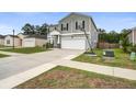Two-story home in a suburban neighborhood featuring an attached garage and well-maintained yard at 309 Squire Pope Rd Rd, Summerville, SC 29486