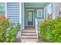 Inviting front porch featuring wood steps and a stylish glass front door at 310 Marchman St, Summerville, SC 29486