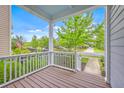 Covered front porch view showcasing neighborhood street lined with trees and sidewalks at 310 Marchman St, Summerville, SC 29486