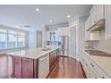 Bright kitchen with large island, stainless steel appliances, and hardwood floors at 310 Marchman St, Summerville, SC 29486
