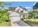 Traditional two-story home with a two-car garage and landscaped front yard at 340 Albrighton Way, Moncks Corner, SC 29461