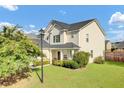 Charming two-story home with a well-maintained lawn and inviting front porch at 340 Albrighton Way, Moncks Corner, SC 29461