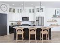 Modern kitchen with stainless steel appliances, a large island with bar seating, and stylish pendant lighting at 342 Trailmore Ln, Summerville, SC 29486