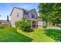 Charming two-story home with a well-maintained lawn and attractive landscaping in a serene setting at 407 Glenmore Dr, Moncks Corner, SC 29461