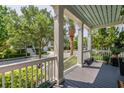 Inviting front porch with white columns offering a view of the street and mature landscaping at 4073 Blackmoor St, Mount Pleasant, SC 29466