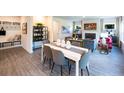 Open-concept dining area leading to a comfortable living room with a fireplace at 421 Radiant Blue Way, Summerville, SC 29486