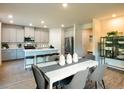 Modern kitchen with stainless steel appliances, a central island and adjacent dining area at 421 Radiant Blue Way, Summerville, SC 29486