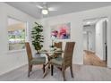 Cozy dining area with a glass table, stylish wicker chairs, and ample natural light from the window at 5172 Sterrett St, North Charleston, SC 29405