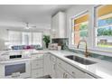 Bright kitchen featuring white cabinets, stainless steel sink, and modern appliances and finishes at 5172 Sterrett St, North Charleston, SC 29405