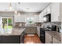 Modern kitchen with white cabinets, granite countertops, stainless steel appliances and access to the backyard at 535 Crossland Dr, Moncks Corner, SC 29461