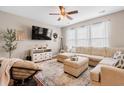 Cozy living room featuring a sectional sofa, modern television, and a stylish accent chair at 535 Crossland Dr, Moncks Corner, SC 29461