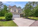 Charming home featuring a two-car garage, well-kept landscaping, and a welcoming entrance at 5725 Caviar Ct, Johns Island, SC 29455