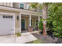 Inviting front porch view displaying address number, rocking chairs, and tasteful landscaping at 5725 Caviar Ct, Johns Island, SC 29455