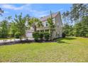 Side view of a two-story home highlighting the lush greenery and well-maintained lawn at 5725 Caviar Ct, Johns Island, SC 29455
