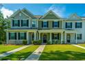 Inviting townhomes feature well-maintained lawns and colorful facades, enhancing the curb appeal at 618 Ravensridge Ln, Moncks Corner, SC 29461
