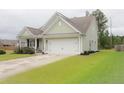 A delightful house with a well-maintained lawn and a spacious two-car garage at 683 Yellow Leaf Ln, Summerville, SC 29486
