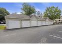View of multiple garages with white doors in a row, providing ample parking and storage at 700 Daniel Ellis Dr # 10305, Charleston, SC 29412