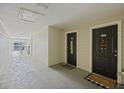 Hallway of condo building with two doors and welcome mats on the floor at 700 Daniel Ellis Dr # 10305, Charleston, SC 29412