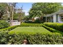 Beautifully landscaped front yard with manicured hedges and lawn, showcasing a home's inviting curb appeal at 708 Pitt St, Mount Pleasant, SC 29464