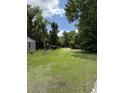 View of the lot, with trees and a shed at 7413 N Highway 17, Awendaw, SC 29429
