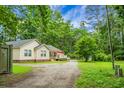 Exterior view of the home with a storage container and plenty of surrounding trees at 785 Coral Acres Dr, Moncks Corner, SC 29461
