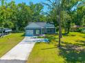 Charming single-story home with a lush green lawn and a long driveway leading to an attached garage at 8453 Charleston Hwy, Walterboro, SC 29488