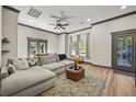 Spacious living room featuring a comfortable sectional sofa, stylish rug, and natural light from the large windows at 8453 Charleston Hwy, Walterboro, SC 29488