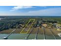 Aerial view of a waterfront lot outlined in yellow, ready for a custom-built home with private dock access at 0 Doar Rd, Awendaw, SC 29429