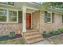 Inviting front entrance showcasing brick steps and a red door with sidelight windows, adding curb appeal at 1 Bossis Dr, Charleston, SC 29407