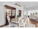 Bright dining room with modern lighting, hardwood floors, and views into the living room at 1003 Jervey Point Rd, Wando, SC 29492